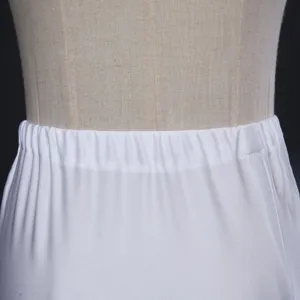 Detail shot of white elastic waistband petticoat skirt support, showing clean fabric craftsmanship.