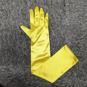 Long yellow satin evening gloves detail view, smooth spandex fabric for wedding or party.