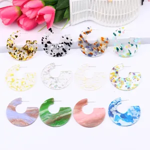 Close-up detail of colorful C-shaped acrylic resin glitter gemstone earrings, 12 styles.