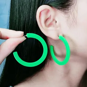 Neon green acrylic C-shape hoop earrings for women, minimalist candy color statement jewelry.