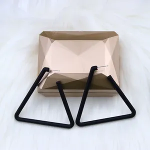 Black geometric triangle stud earrings detail view, minimalist fashion jewelry design.