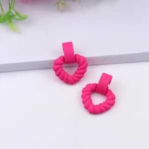 Pink matte heart-shaped drop earrings close up detail, stylish acrylic daily jewelry piece