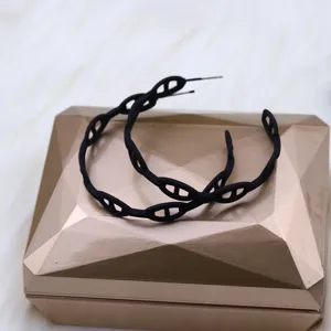 Black hollow geometric chain hoop earrings close-up, stylish design, perfect accessory details.
