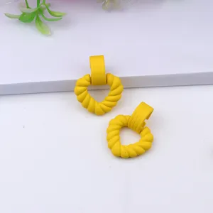 Yellow acrylic twisted heart earrings, simple geometric dangle earrings for women fashion.