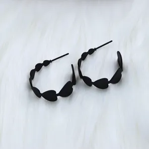 Black heart hoop earrings detail, stylish hollow geometric design for women jewelry.