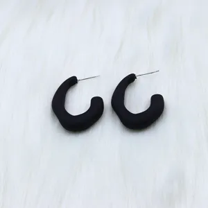 Matte black irregular geometric hoop earrings detail view, minimalist fashion jewelry for women.