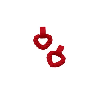 Red twisted heart acrylic stud earrings for women, simple and stylish matte drop earrings.