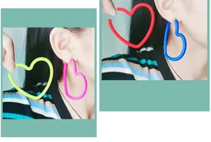 Gros plan détaillé de boucles d'oreilles créoles cœur néon vibrantes aux couleurs audacieuses.