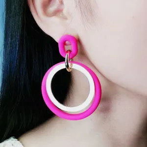 Exaggerated fashion acrylic hollow circle spliced earrings with vibrant pink and white design.