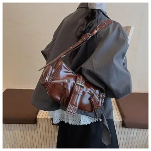 Dark brown patent leather motorcycle shoulder bag with multi zippers, chic urban style.