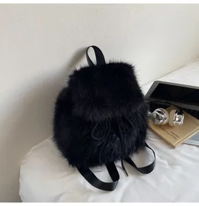 Close-up detail view of a stylish black fluffy plush backpack with soft furry texture.
