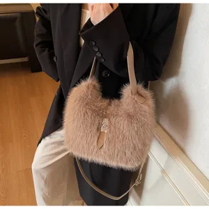 Close up of fashionable plush bucket bag with metal lock and leather strap, exquisite texture.