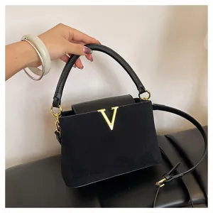 Elegant black top-handle shoulder bag with gold V logo for women chic daily commute style.