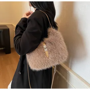 Detail view of a stylish plush shoulder bag in khaki faux fur with metallic lock. Perfect choice.