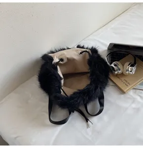 Detailed view of fluffy black faux fur drawstring backpack for women autumn winter fashion casual.