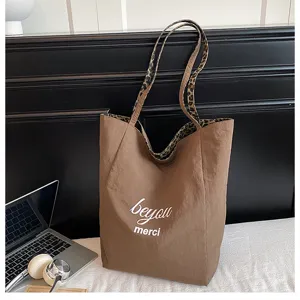 Brown canvas tote bag with leopard print straps, casual large capacity shoulder bag for daily use.