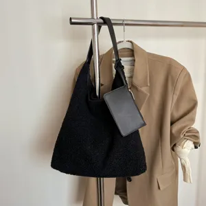 Black sherpa shoulder bag for women, large capacity winter tote with a small pouch.