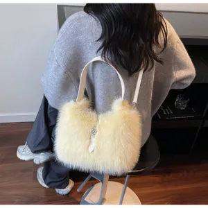 Chic plush shoulder bag for women, fluffy faux fur crossbody bucket bag with white strap.