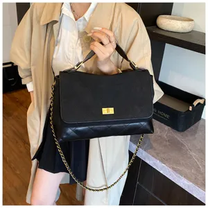 Black quilted flap crossbody bag with metal chain strap, classic commuter handbag detail.