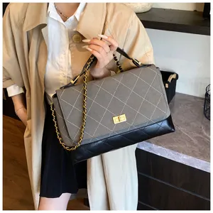 Grey quilted suede patchwork flap shoulder bag with gold chain strap and metal turn-lock closure.