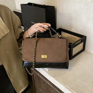 Classic quilted shoulder bag with chain strap, brown suede and black leather patchwork.