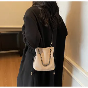 Chic beige bucket bag with chain strap and drawstring design, stylish daily crossbody bag.