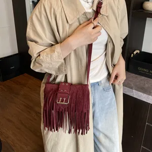 Chic women suede fringe crossbody bag in dark red retro style with buckle for daily use.