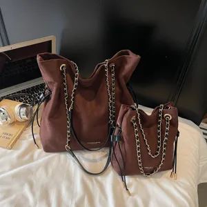 Brown suede chain drawstring tote bag and matching handbag set for women commuter daily use.