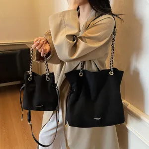 Stylish black chain drawstring tote and shoulder bag set, versatile everyday commuter handbag.