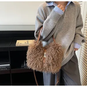 Close-up view of fluffy plush handbag with leather strap and metal clasp detail in use.