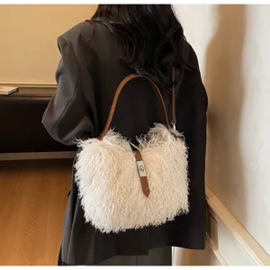 Detailed shot of fluffy white shoulder bag with brown leather strap and metal turn-lock.