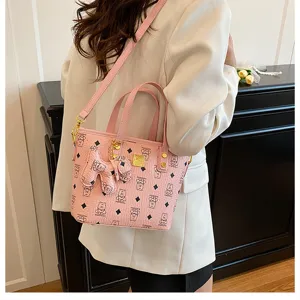Chic pink bucket bag for women, stylish shoulder handbag with cute pattern and handle.