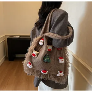 Cozy brown knitted Christmas tote bag featuring cute plush patches and stylish fringe.