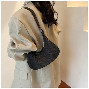 Dark denim crescent shoulder bag for women, trendy fall crossbody dumpling bag, chic style.