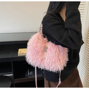 Pink fluffy plush shoulder bag detail, soft shaggy texture, metal twist lock, slim strap.