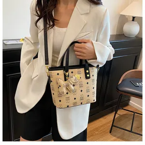 Chic PU leather bucket bag with cute bear pendant, trendy monogram shoulder crossbody bag for women