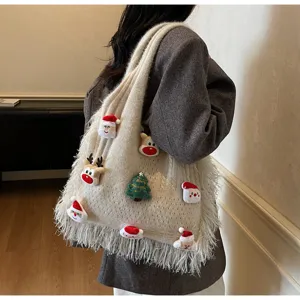 Detail shot of Christmas knitted tote bag with festive plush elements and chic fringe trim.