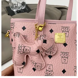 Pink leather bucket bag with diamond pattern and cute bear print for women detail.