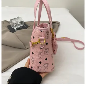Pink cute bear print bucket bag for women, stylish leather handbag with shoulder strap.