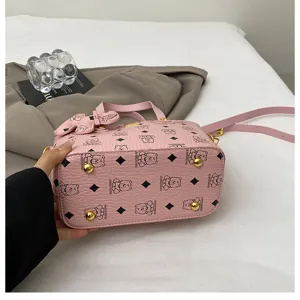 Pink bucket bag detail showing cute bear print, leather material, and metal feet design.