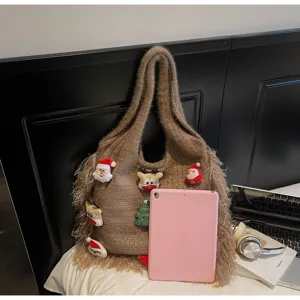 Detailed view of Christmas knit tote bag, featuring cute plush pendants and stylish tassels.