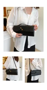 Schwarze gewebte Leder Baguette Schultertasche mit edlem Metallsitz und vielseitigem Gurt.