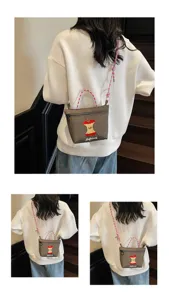 Detailed view of the cute nylon crossbody bag featuring a playful embroidered apple core design.