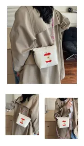 Cute Japanese style canvas crossbody bag detail, featuring apple core design and strap.