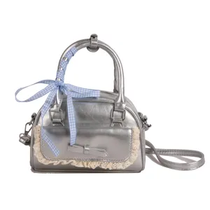 Stylish silver crossbody handbag for women with cute lace trim and chic blue ribbon bow.