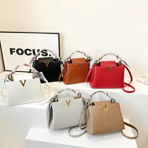 Lychee pattern leather handbag with scarf handle and metal V logo, stylish crossbody bag.