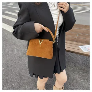 Brown suede retro shoulder bag with gold V clasp, stylish commuter handbag for women.