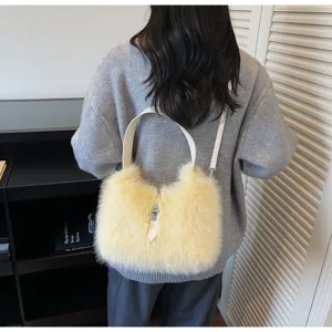 Detail view of a fluffy plush shoulder bucket bag in yellow, elegant autumn winter style.