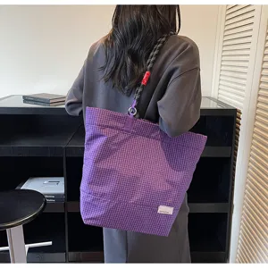 Purple plaid tote bag detail view, casual shoulder bag with thick strap and spacious interior.