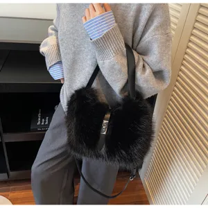 Stylish black faux fur shoulder bag for women, cozy winter crossbody bucket bag with lock.